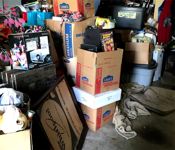 Sorted And Organized Items Remaining After House Fire Sitting In Storage Garage.